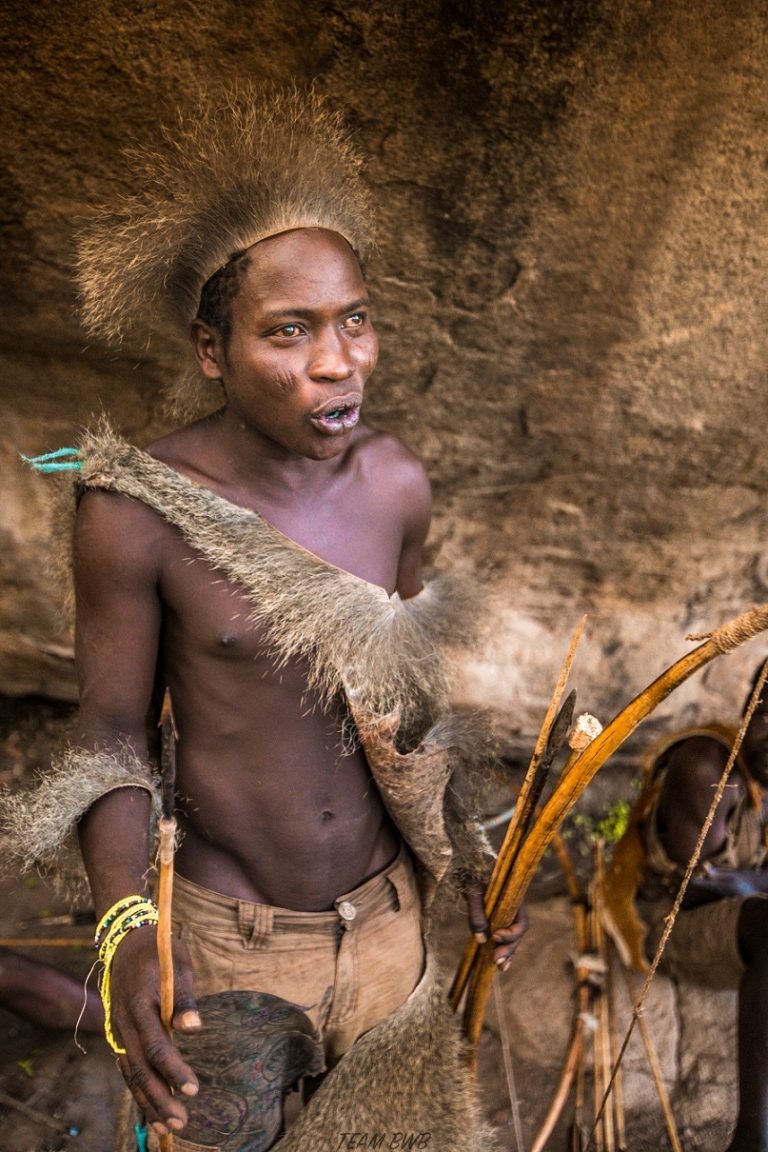 Hadzabe hunter holding his arrows at a rock shelter