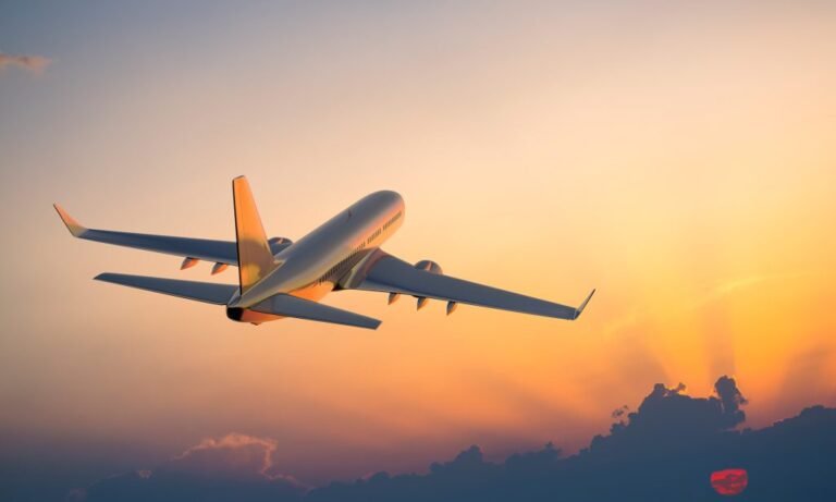 Passenger aircraft in flight above the clouds at sunset