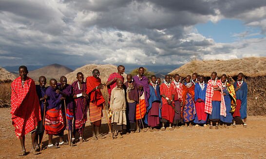 Maasai community gathered in traditional red and purple shukas